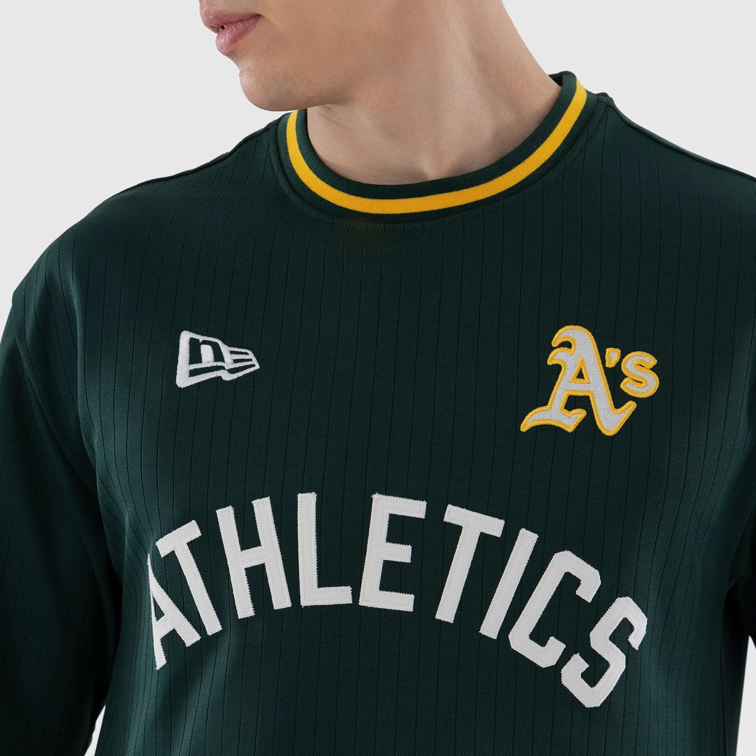 The model is wearing this MLB Athletics Oversized T-Shirt in dark green. 4