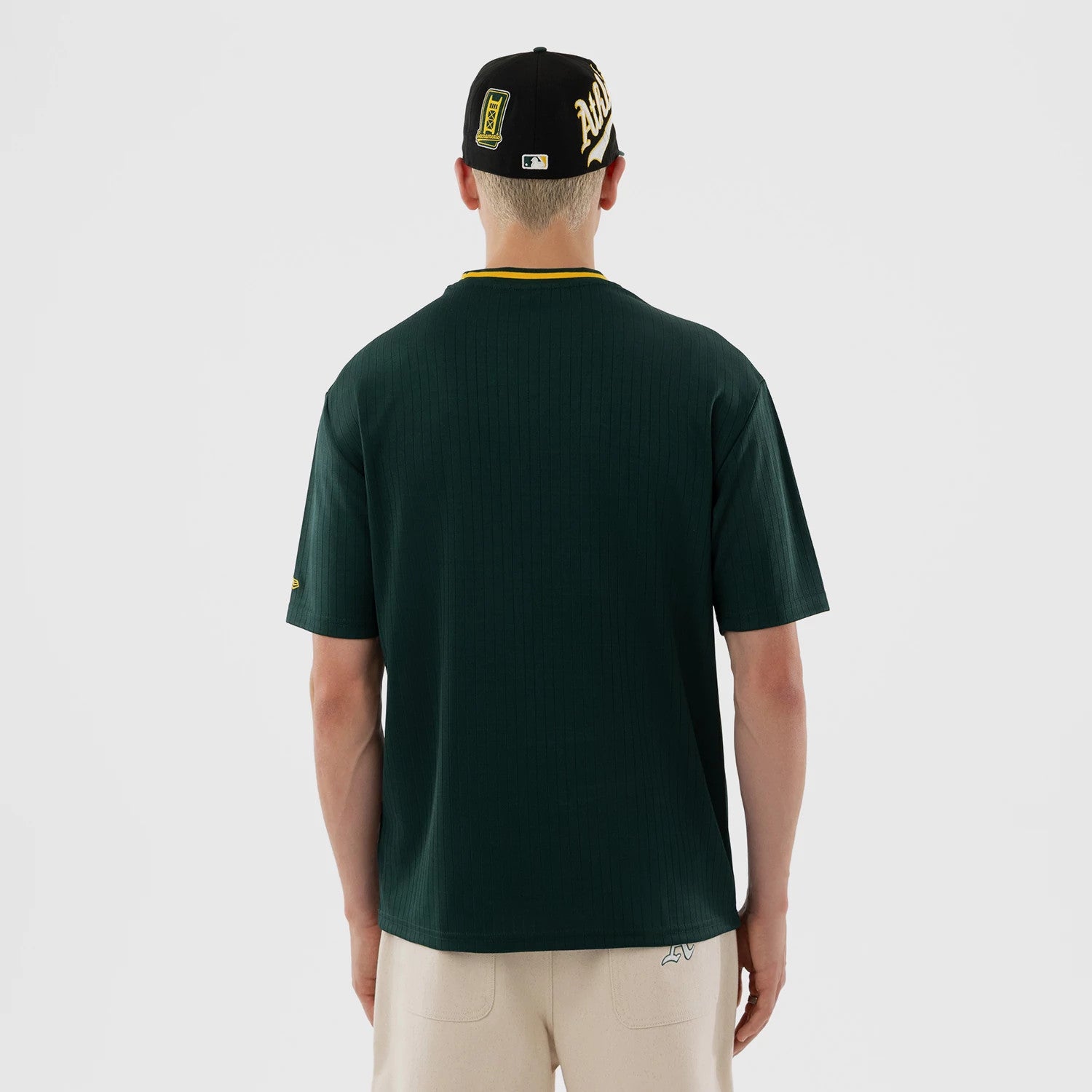 The model is wearing this MLB Athletics Oversized T-Shirt in dark green. 2