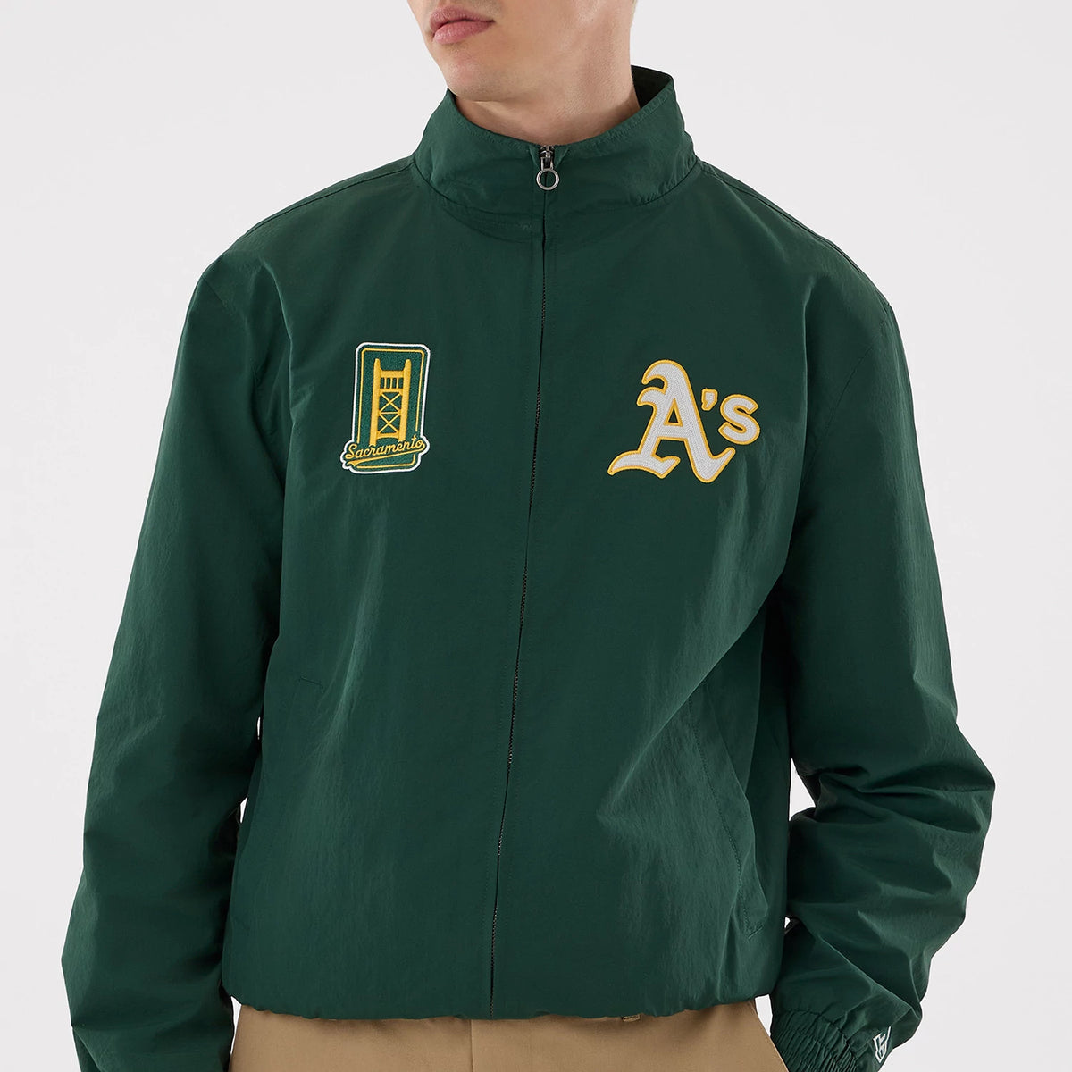 The model is wearing this MLB Athletics Sports Jacket in dark green. 3