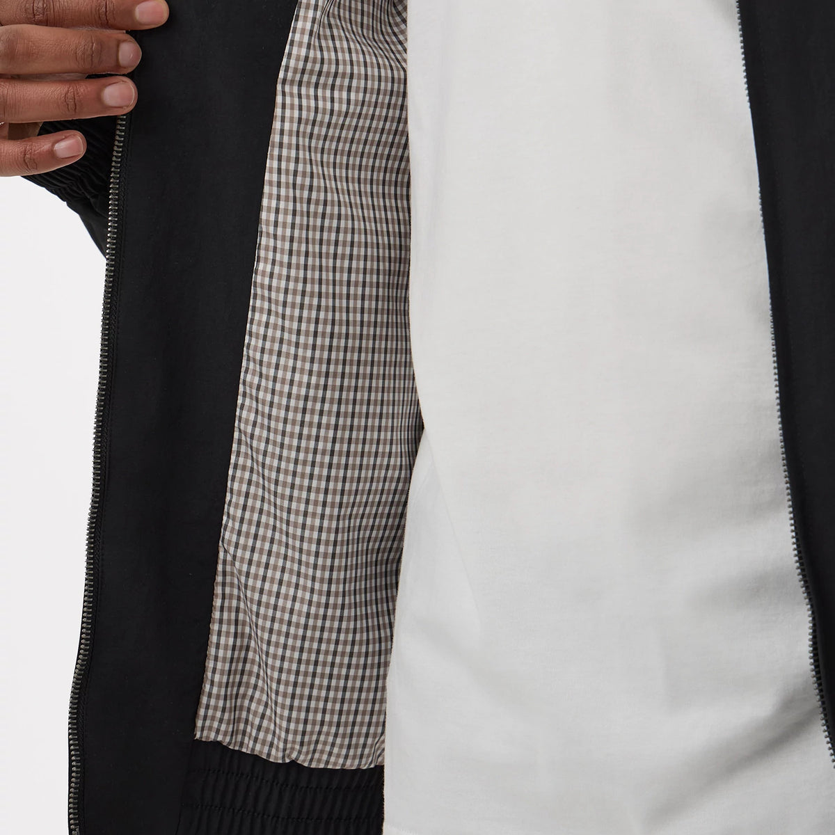 New Era LA Dodgers MLB Black Sports Jacket, open view showing the black outer with a zip along the edge, revealing a checked inner lining in white and brown, worn over a plain white shirt.