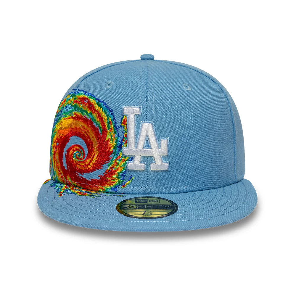 LA Dodgers MLB Storm Pattern Pastel Blue New Era 59FIFTY Fitted Cap, front view showing the prominent white LA embroidered logo on the front panel, a multicoloured storm swirl patch on the side, and a gold 59FIFTY size sticker on the flat visor.