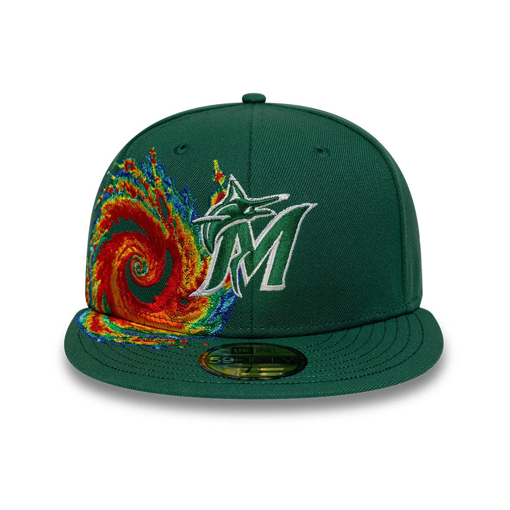 Miami Marlins MLB Storm Pattern Dark Green New Era 59FIFTY Fitted Cap, front view showing the multicoloured embroidered swirl design on the left panel, raised white Marlins logo on the front, and the green 59FIFTY size sticker on the visor.