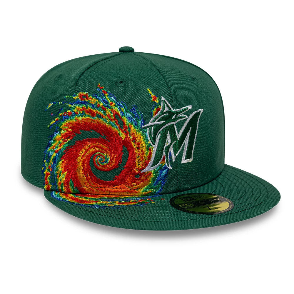 Miami Marlins MLB Storm Pattern Dark Green New Era 59FIFTY Fitted Cap, front view showing the intricate embroidered storm graphic in vivid red, yellow, and blue swirls beside the grey and white M logo, with a flat dark green visor.
