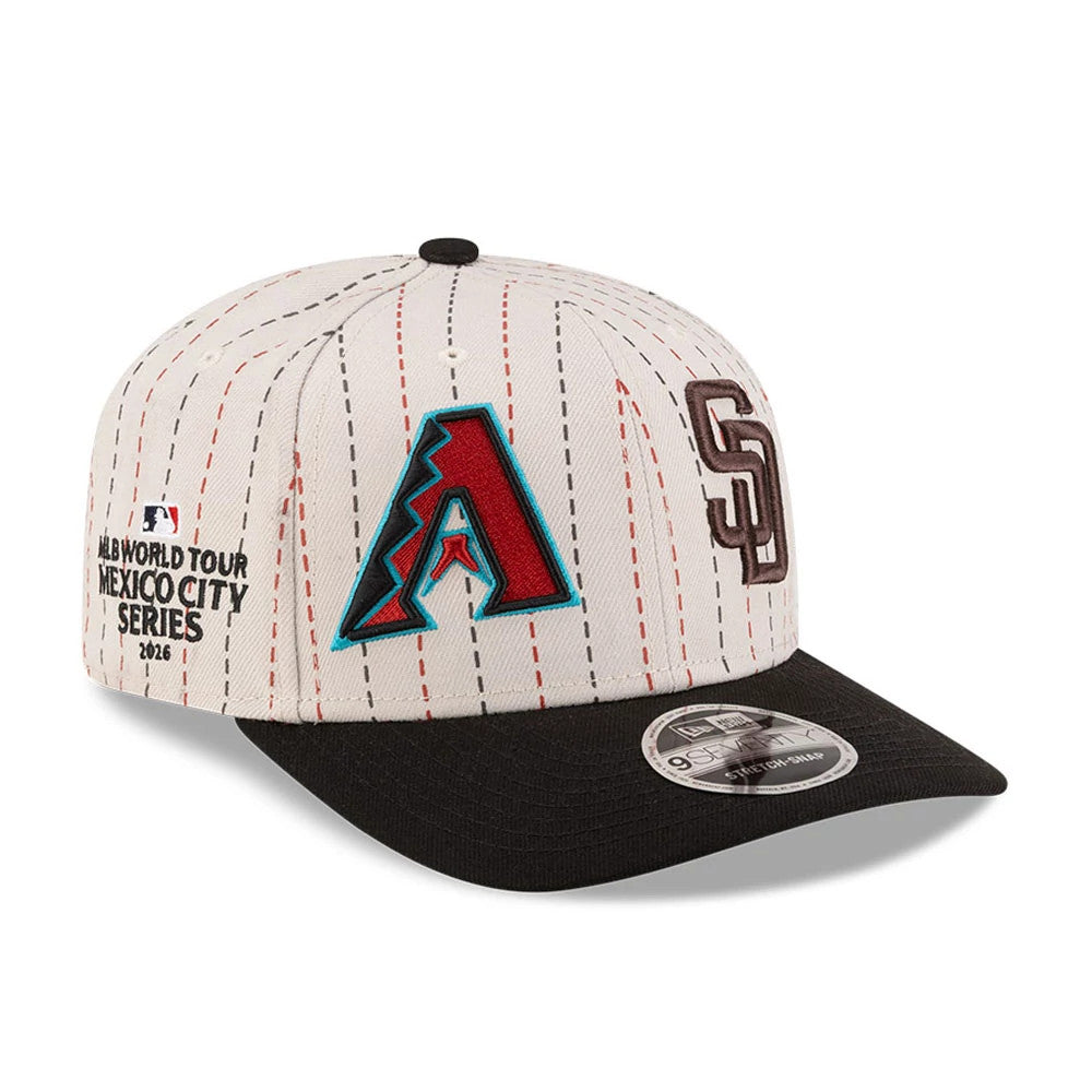 Dueling League MLB Mexico City Series 2026 Light Beige New Era 9SEVENTY Stretch Snap Adjustable Cap, three-quarter view showing raised embroidered logos for Arizona Diamondbacks and San Diego Padres, with a black curved visor.