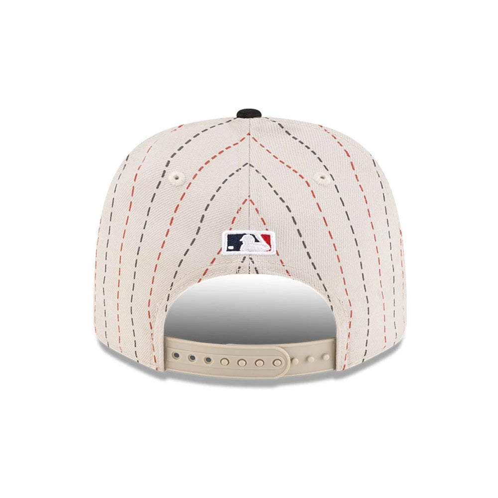 Dueling League MLB Mexico City Series 2026 Light Beige New Era 9SEVENTY Stretch Snap Adjustable Cap, rear view showing the embroidered MLB Batterman logo centred on the light beige back panels with red and black pinstripes.