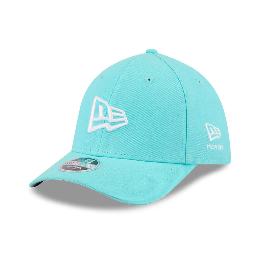 New Era Flag Pastel Blue New Era 39THIRTY M-Crown Stretch Fit Cap, three-quarter view showing the white raised embroidered New Era flag logo on the front panel and left side, with a silver 39THIRTY size sticker on the curved visor.