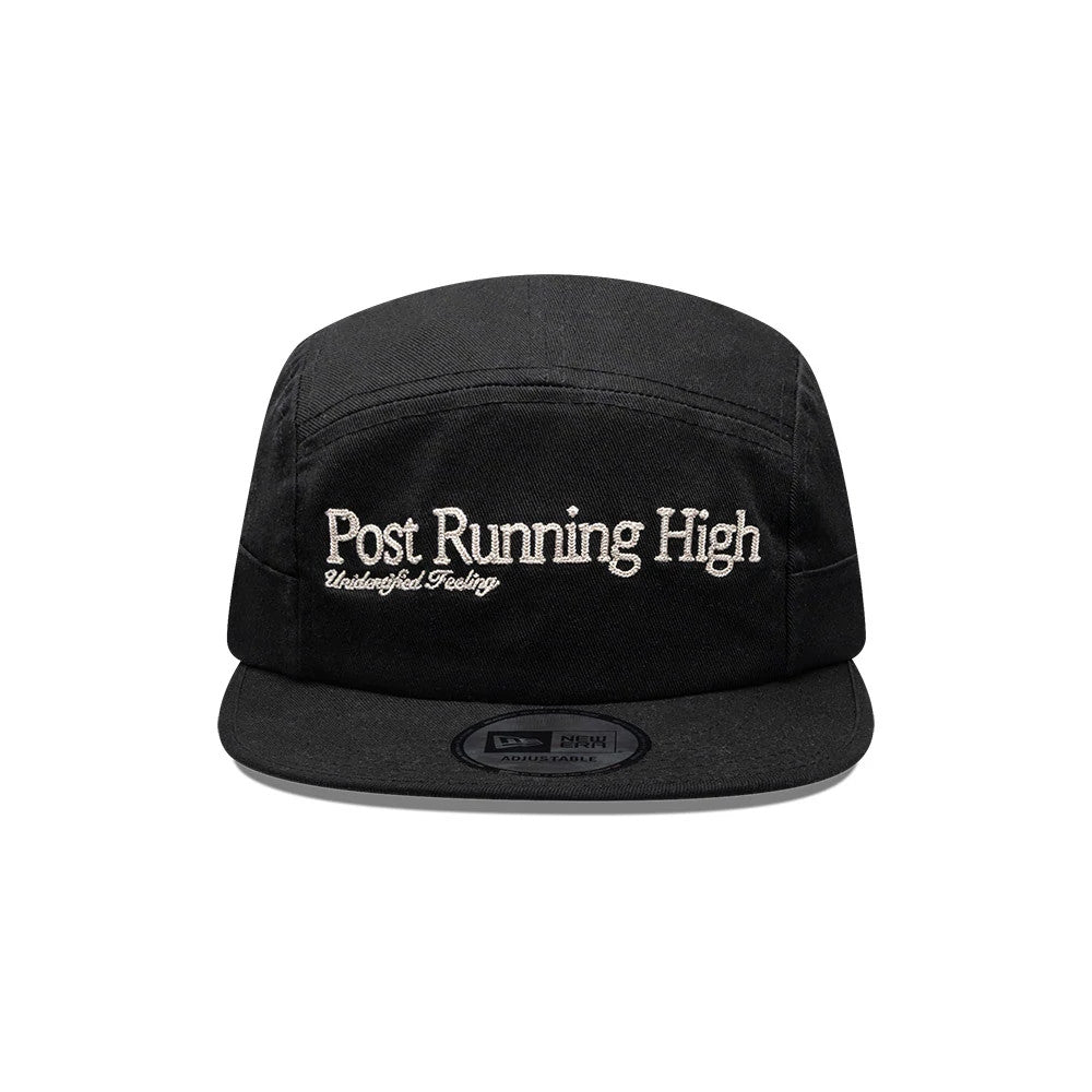 New Era X Hermanos Koumori Running Black Camper Cap, front view showing white embroidered Post Running High and Undefined Feeling text on the front panel, with a black flat visor and a centred black adjustable size sticker.