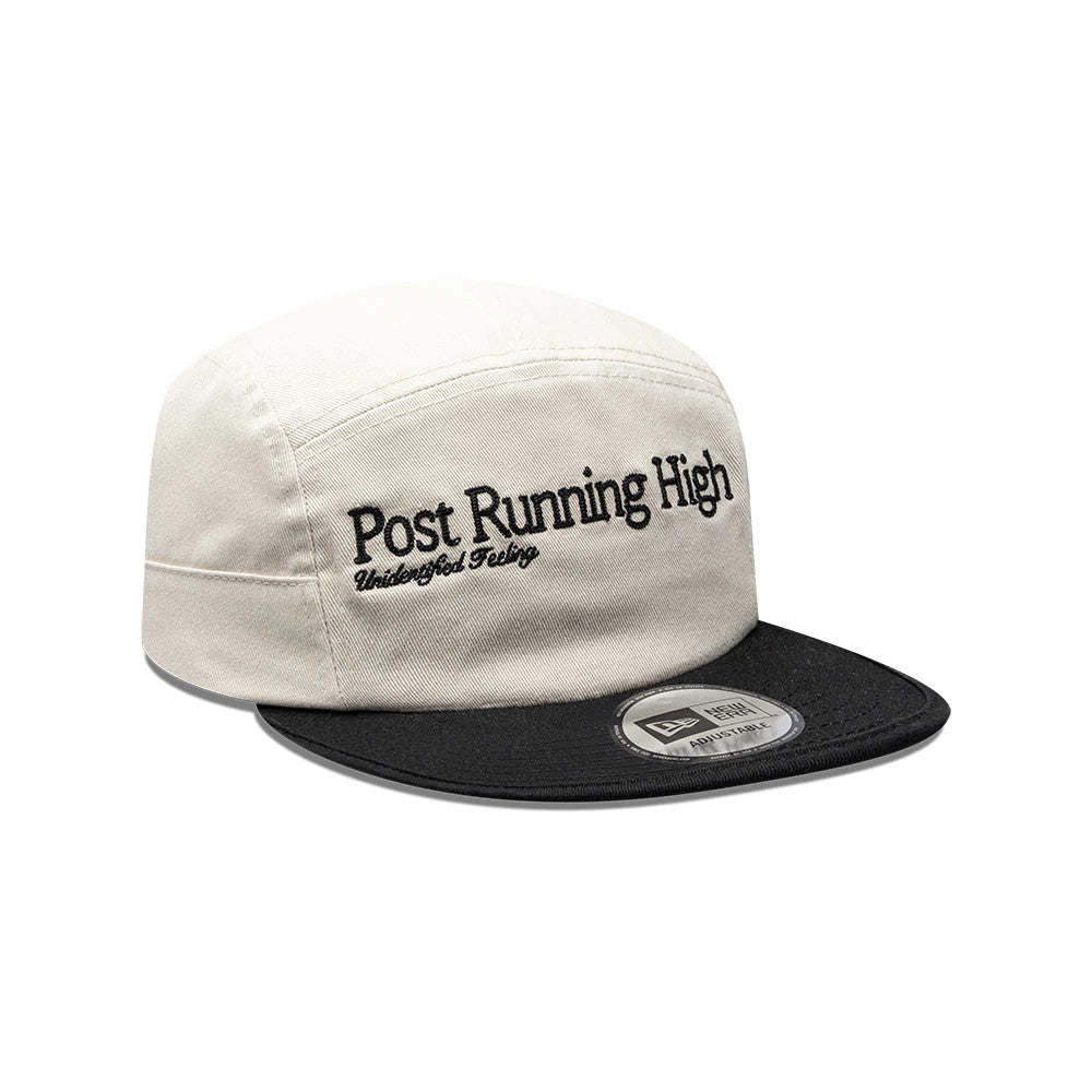 New Era X Hermanos Koumori Running Light Beige Camper Cap, front view showing the black embroidered Post Running High and Undefined Feeling text on the light beige crown, with a flat black visor and the 9FORTY size sticker on the visor.