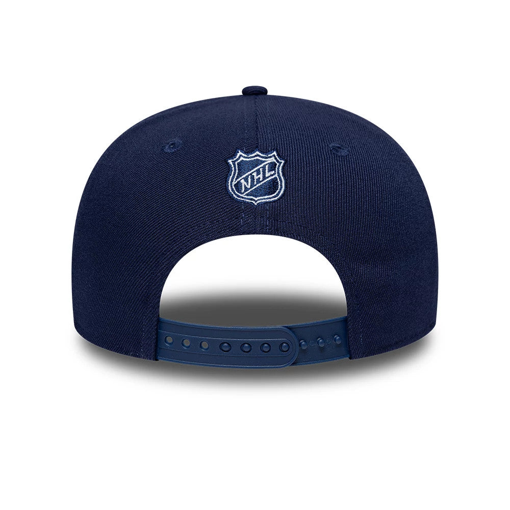 Toronto Maple Leafs NHL Team Navy New Era 9SEVENTY Stretch Snap Adjustable Cap, rear view showing the white embroidered NHL shield logo centred on the back panels above the blue adjustable snap closure and the structured navy crown.