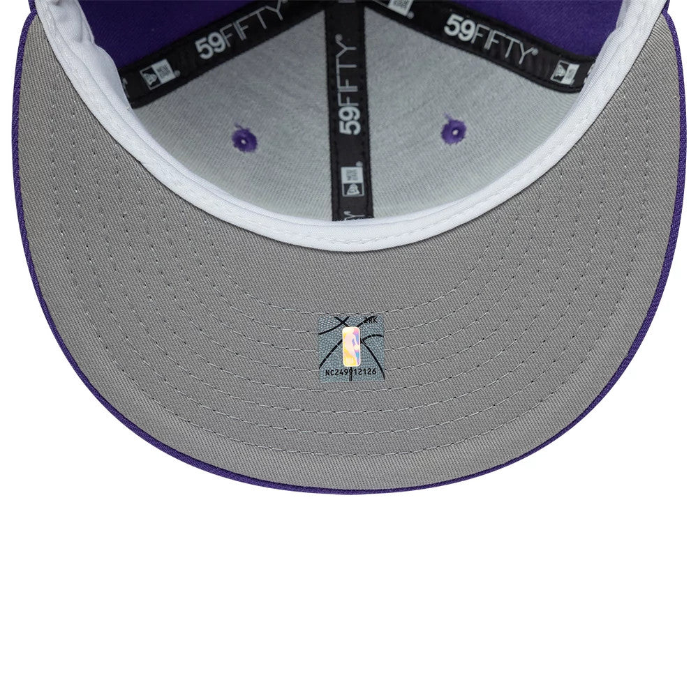 LA Lakers NBA Hardwood Classic Purple New Era 59FIFTY Fitted Cap, inside view with a grey undervisor, black 59FIFTY taping along the seams, purple top button and eyelets, and an NBA authentication sticker at the centre.