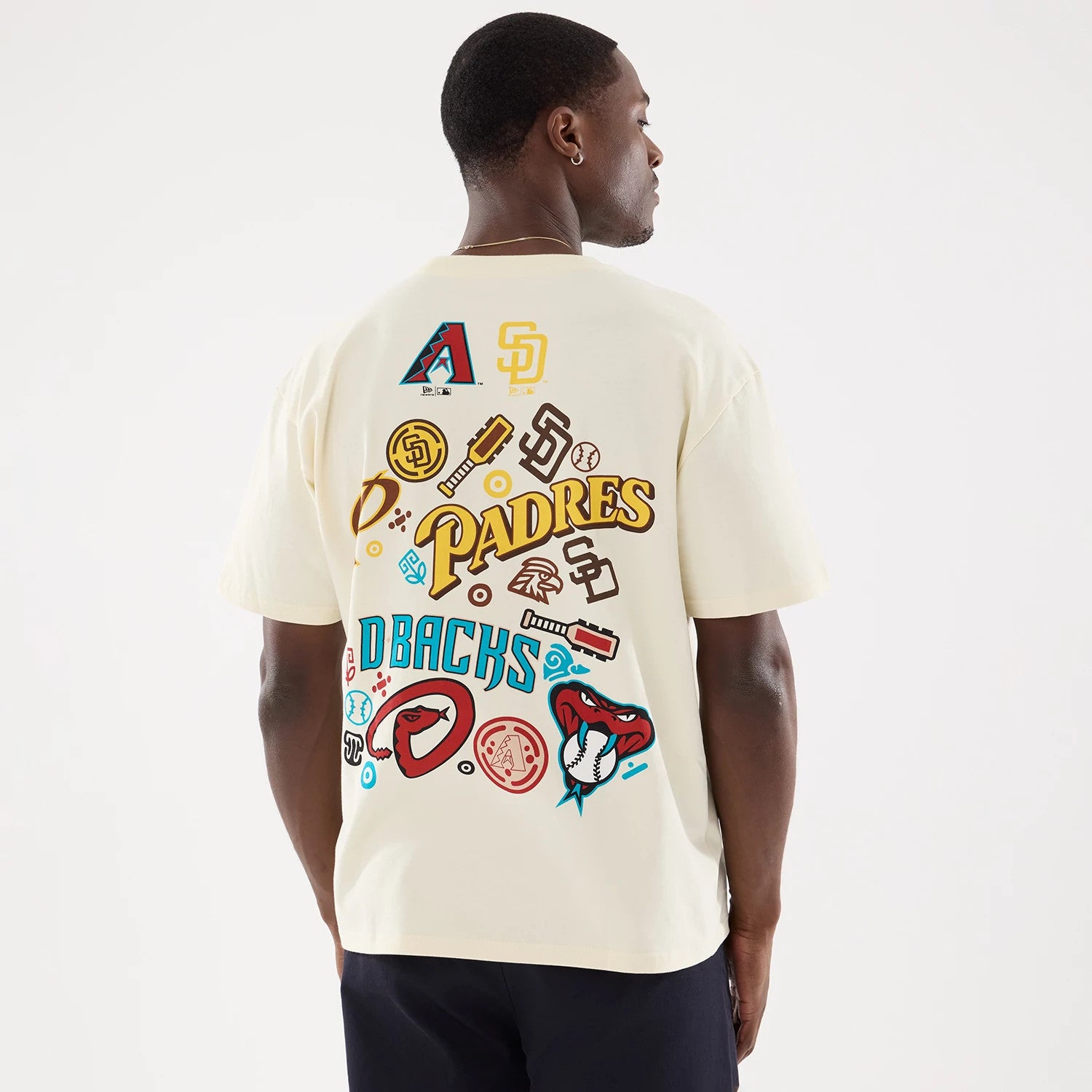 The model is wearing this MLB Mexico City Series 2026 Script Dueling Logo T-Shirt in Cream. 2