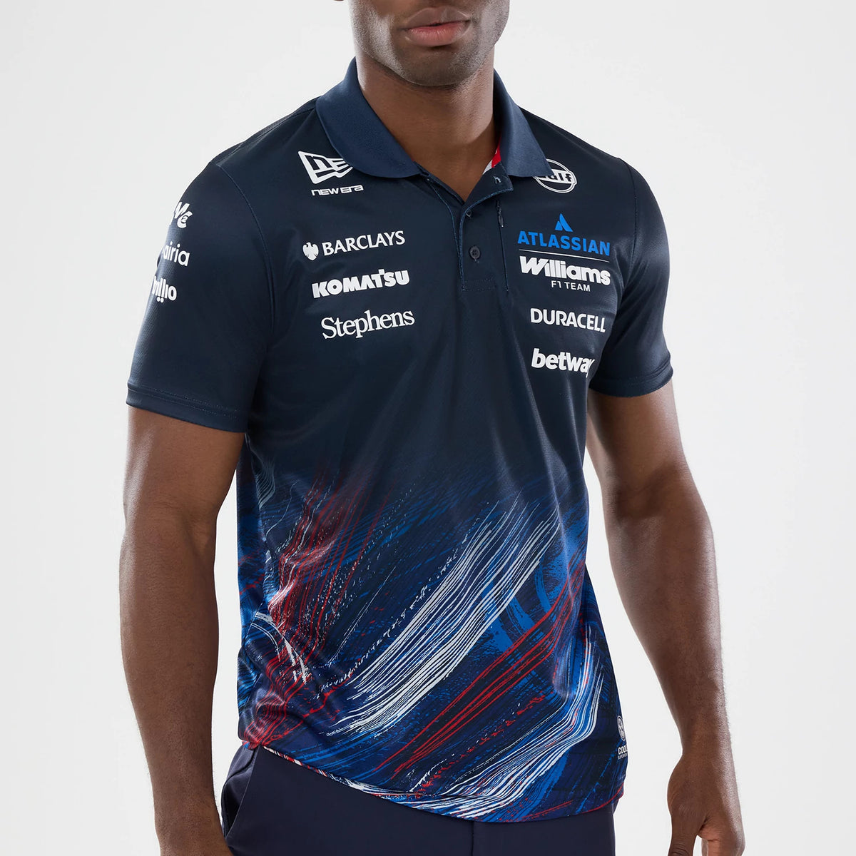 New Era Williams GB Race Special Navy Tech Polo T-Shirt, front view on a model showing multiple sponsor logos like Williams Racing and Duracell printed on the chest and sleeves, with distinctive red, white.