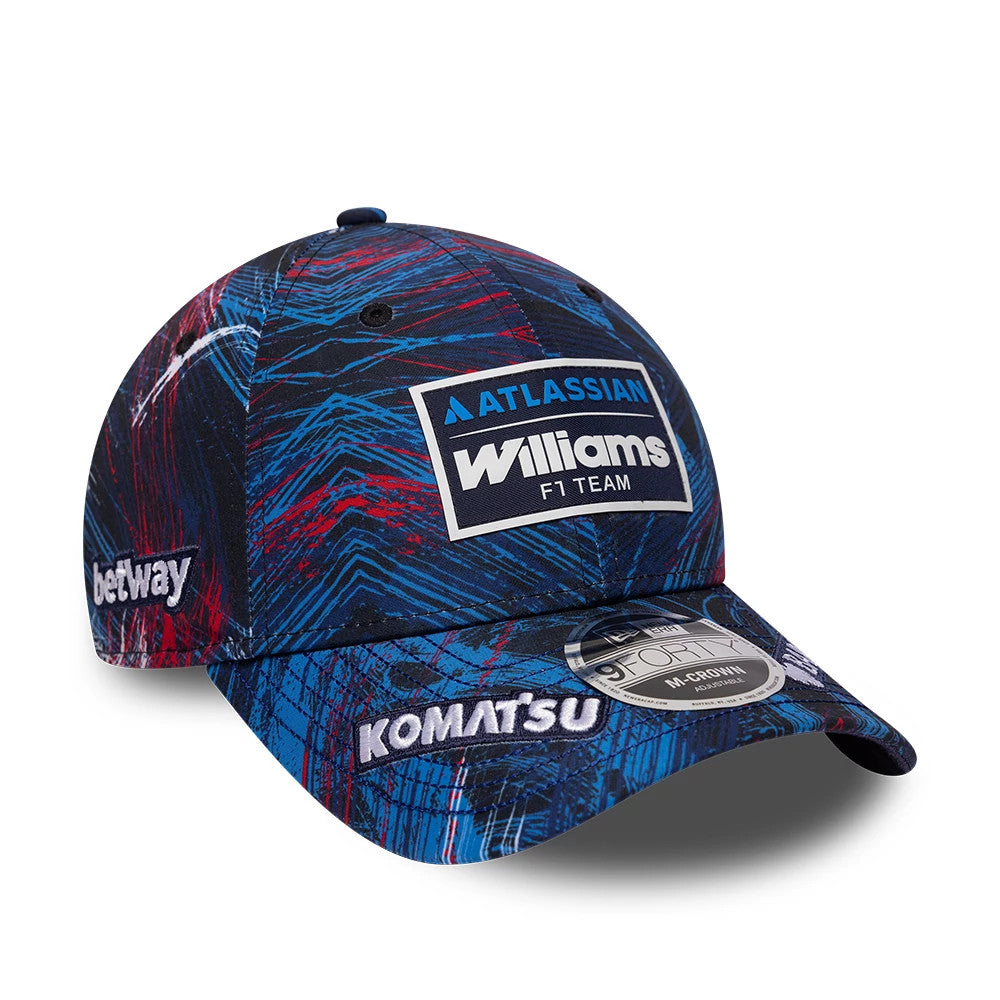 Williams GB Race Special Navy New Era 9FORTY M-Crown Adjustable Cap, front view showing the embroidered Williams F1 Team patch on the crown, a navy and red abstract pattern, and a 9FORTY size sticker on the curved visor.