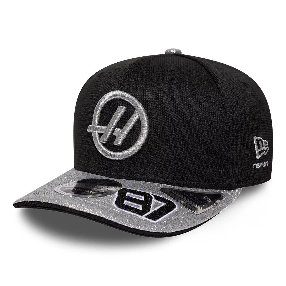 TGR Haas F1 Oliver Bearman Vegas Race Special Black New Era 9SEVENTY Stretch Snap Adjustable Cap, front view showing a raised silver embroidered Haas logo on the structured black crown.
