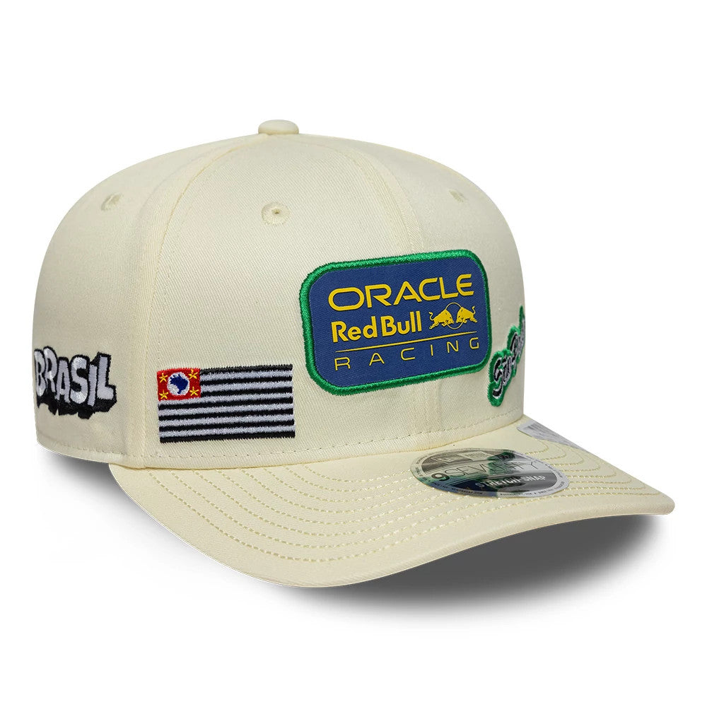 Red Bull Racing Brazil Race Special Team Cream New Era 9SEVENTY Stretch Snap Adjustable Cap, three-quarter view showing a blue and yellow Oracle Red Bull Racing badge, black and white striped flag patch, and Brasil embroidery on the front panel.