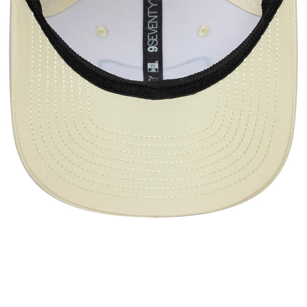 Red Bull Racing Brazil Race Special Team Cream New Era 9SEVENTY Stretch Snap Adjustable Cap, inside view showing a cream undervisor and black sweatband, with cream taping and the 9SEVENTY brand label running along the inside seam.