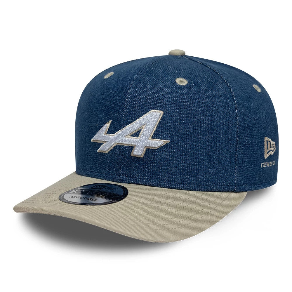 Alpine Racing Austin Race Special Denim Navy New Era 9SEVENTY Stretch Snap Adjustable Cap, front three-quarter view showing the raised white embroidered A logo on the denim navy front panel, khaki visor and New Era flag logo on the left side.