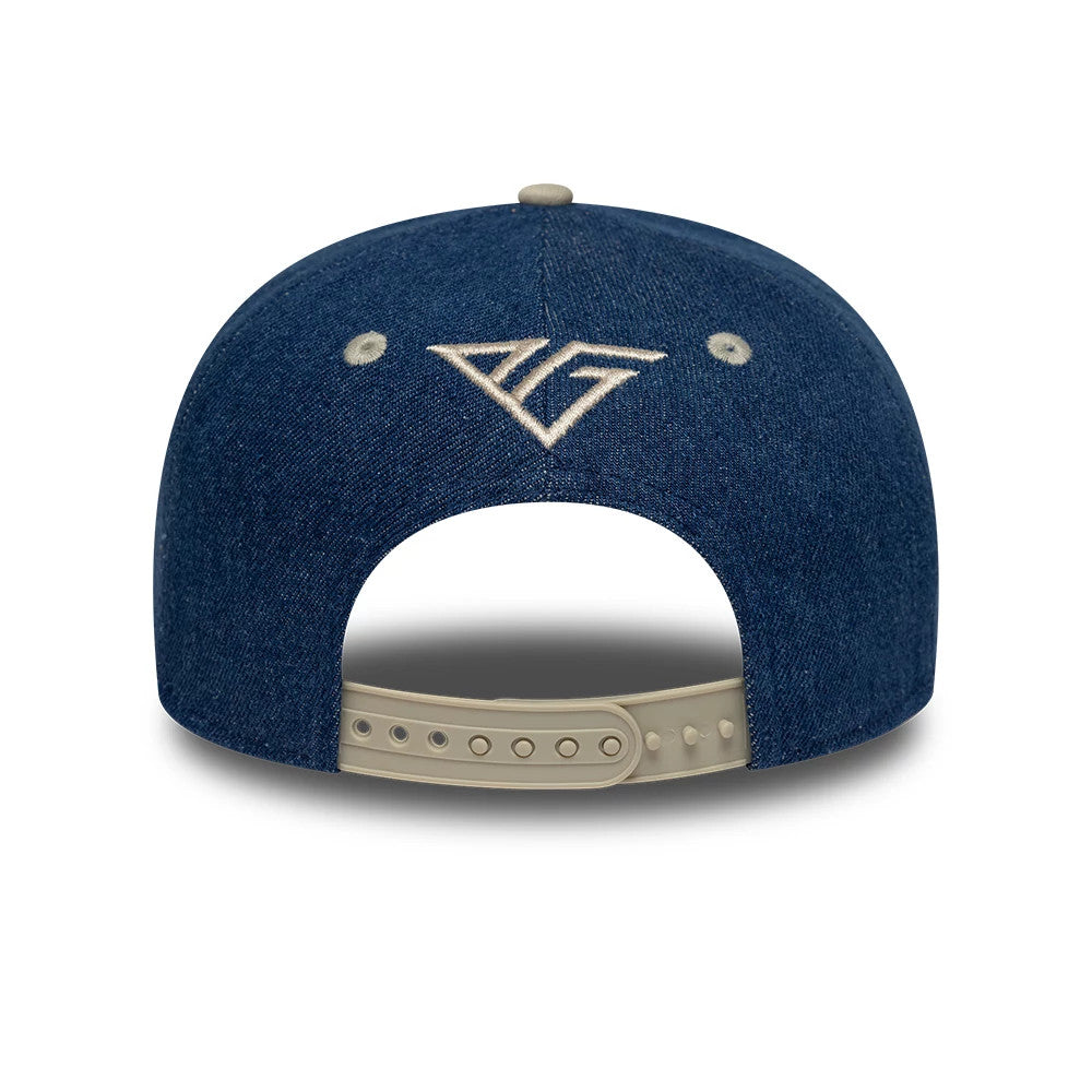 Alpine Racing Austin Race Special Pierre Gasly Navy New Era 9SEVENTY Stretch Snap Adjustable Cap, rear view showing the white embroidered A logo at the centre above the curved opening, with two beige eyelets and a beige snap closure.
