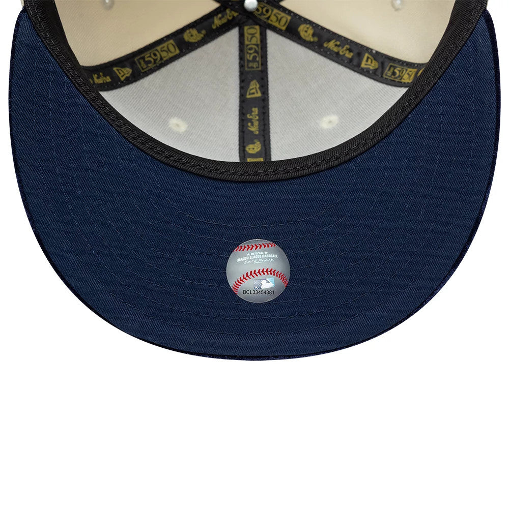 New York Yankees MLB Paisley Visor Cream New Era 59FIFTY Fitted Cap, inside view showing dark blue undervisor with a baseball-shaped holographic sticker, black and gold 59FIFTY taping, and a black sweatband along the edge of the visor.