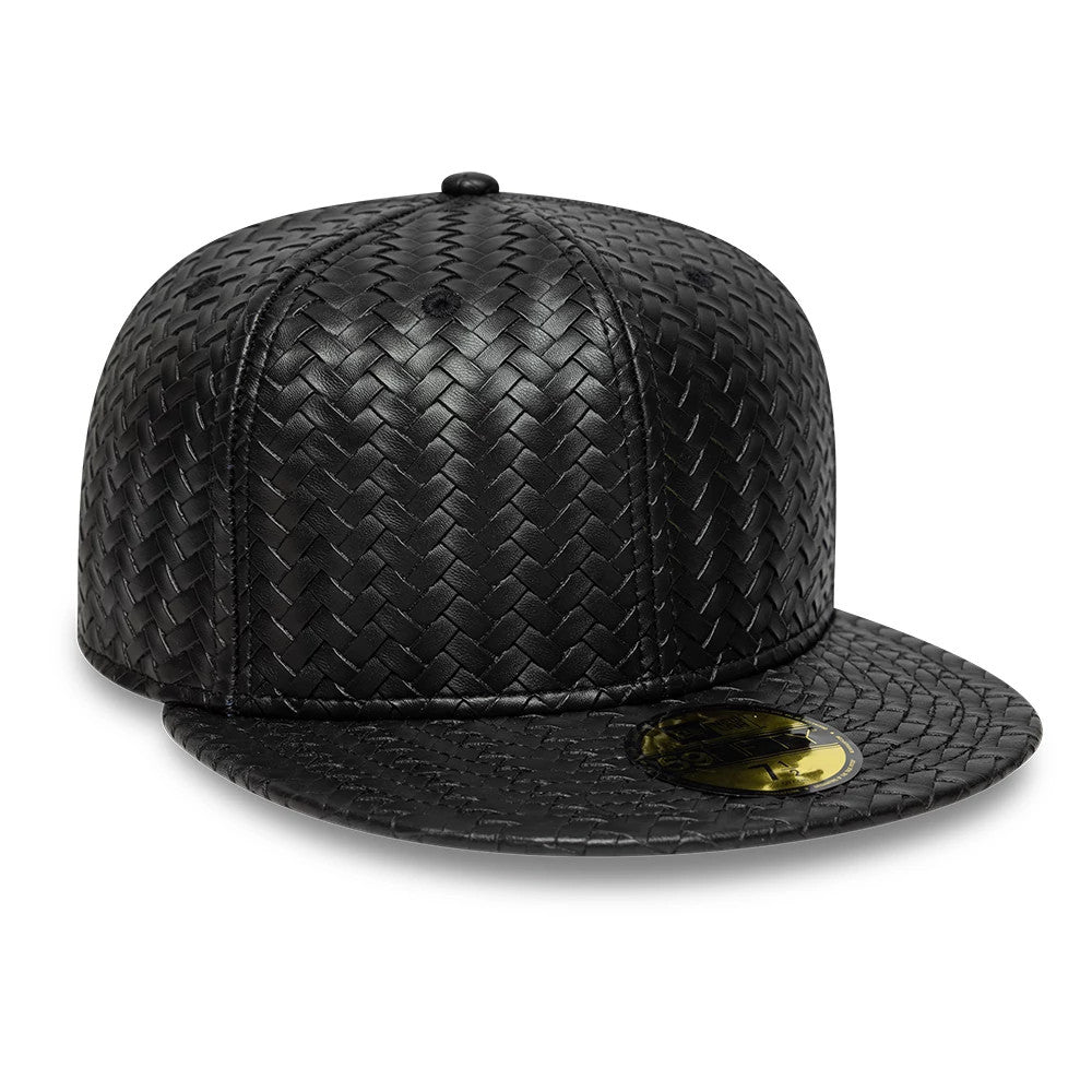 New Era Woven PU Black 59FIFTY Fitted Cap, front view showing a unique basketweave pattern across the entire structured crown and flat visor, with a gold 59FIFTY size sticker on the black visor, and a matching top button.