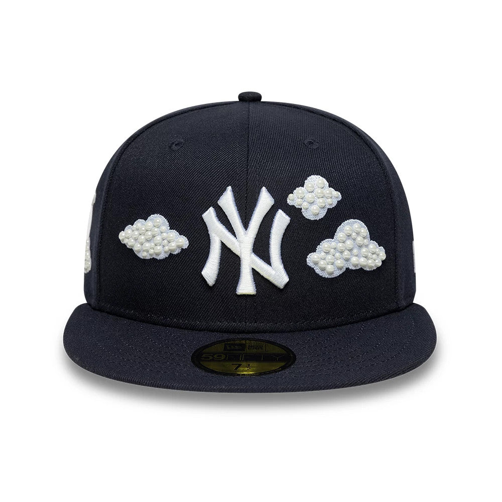 New York Yankees MLB Faux Pearl Cloud Navy New Era 59FIFTY Fitted Cap, front view showing the white embroidered Yankees logo on the structured navy crown, flanked by faux pearl cloud designs, with a gold 59FIFTY size sticker on the flat visor.