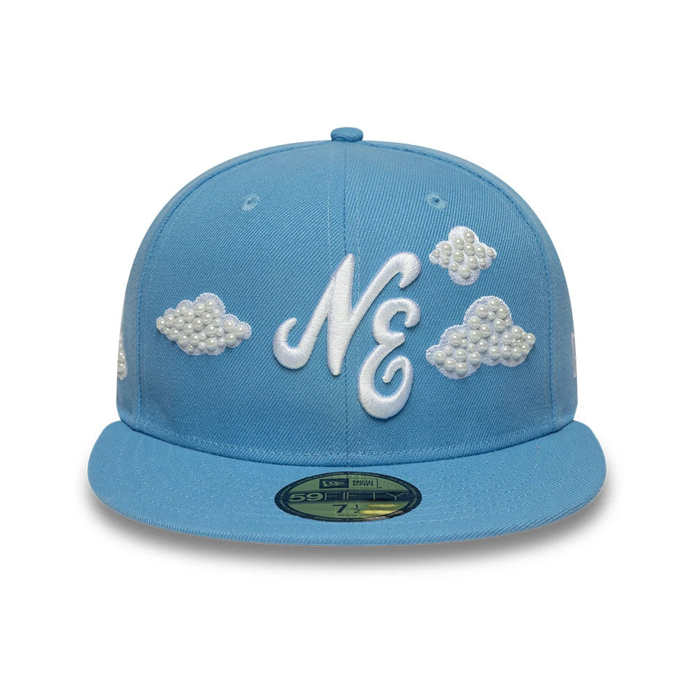 New Era Faux Pearl Cloud Pastel Blue 59FIFTY Fitted Cap, front view showing the white embroidered NE logo with faux pearl cloud designs on the structured pastel blue crown and a gold 59FIFTY size sticker on the flat pastel blue visor.