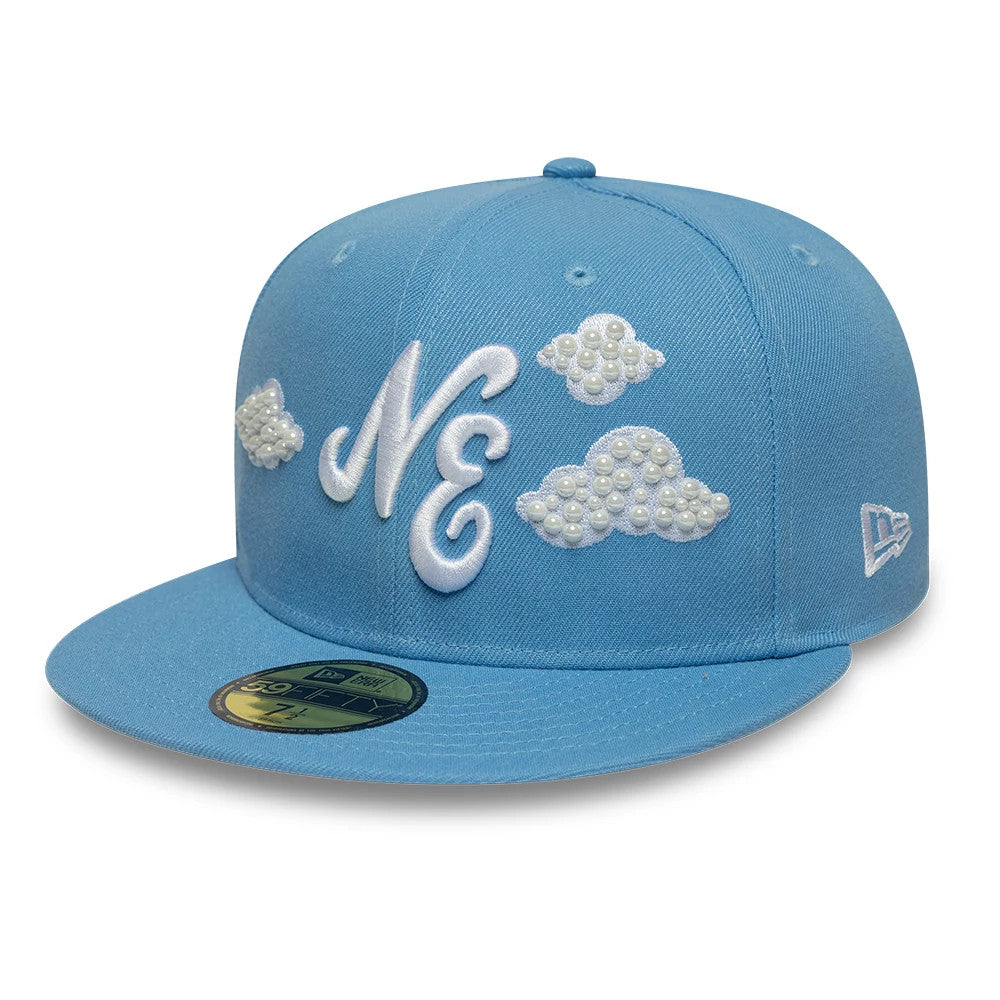 New Era Faux Pearl Cloud Pastel Blue 59FIFTY Fitted Cap, front view showing white raised embroidery of the NE logo and faux pearl cloud designs, with a matching pastel blue flat visor and a gold 59FIFTY size sticker on the visor.