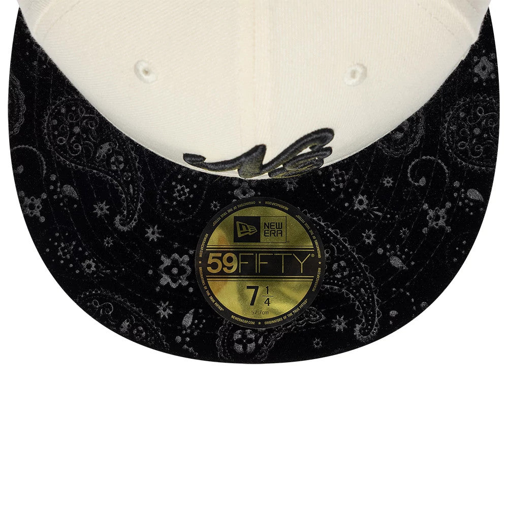 New Era Paisley Visor Light Beige 59FIFTY Fitted Cap, front view showing the gold 59FIFTY size sticker on the black paisley-patterned visor, with the beige crown featuring two eyelets and the New Era flag logo in raised embroidery.