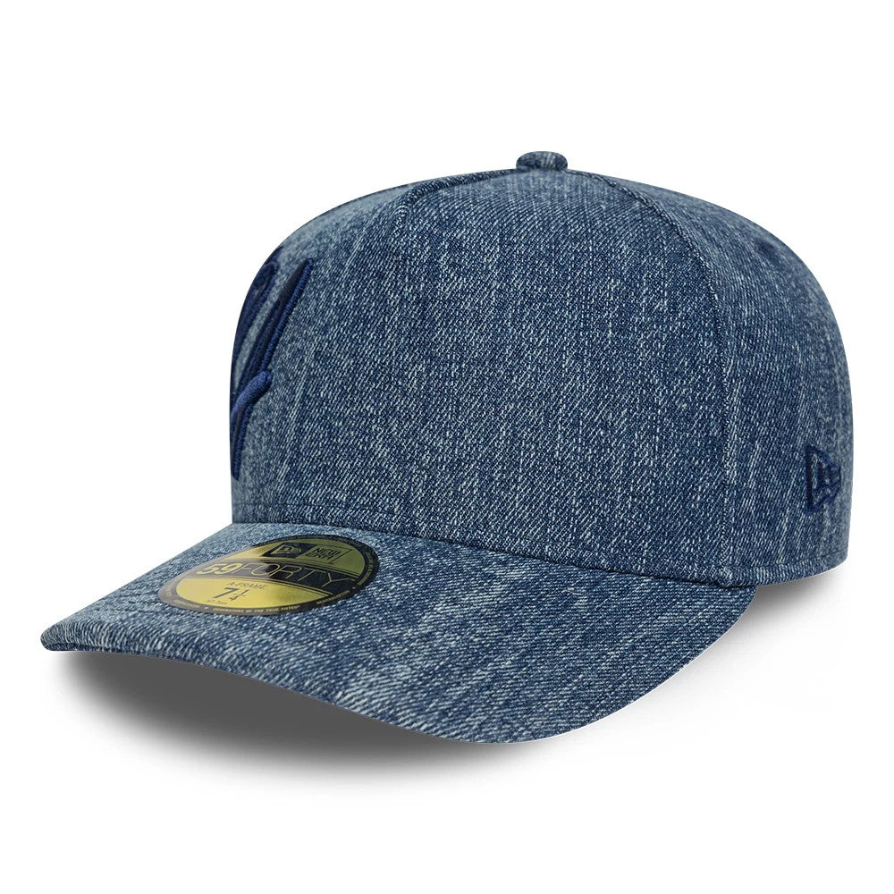 New Era Denim Navy 59FORTY A-Frame Fitted Cap, three-quarter view showing the navy embroidered front logo on the structured denim crown, the curved denim visor with a 59FORTY size sticker, and the New Era flag logo on the left side.