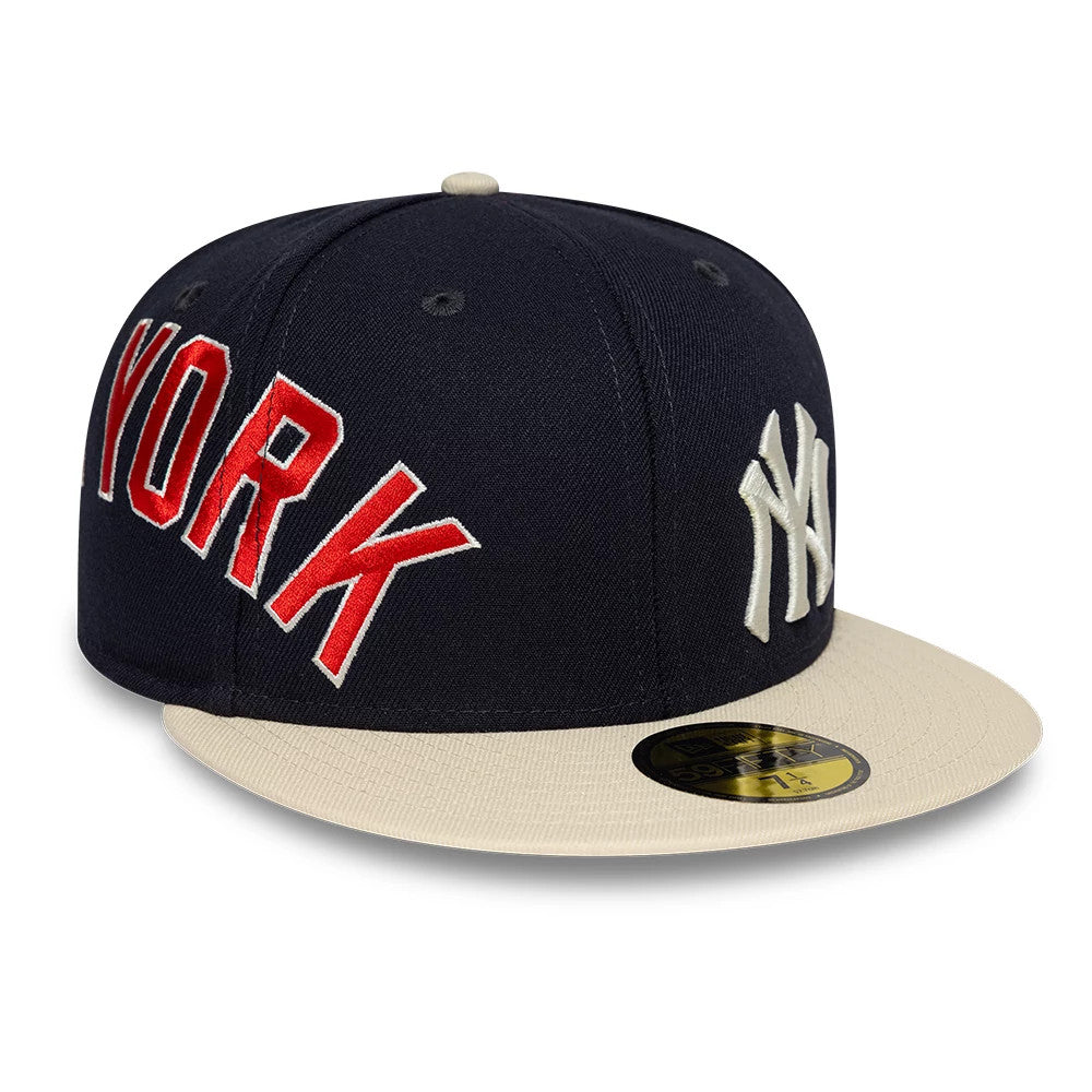 New York Yankees MLB Multi Logo Satin Lined Navy New Era 59FIFTY Fitted Cap, three-quarter view showing raised white NY logo on the front panel, red embroidered YORK on the side, and cream-coloured flat visor with gold 59FIFTY size sticker.