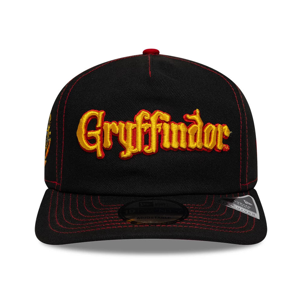 Harry Potter Gryffindor Black New Era 19TWENTY Adjustable Cap, front view showing the yellow and red embroidered Gryffindor logo on the structured crown, with prominent red stitching on the black visor and a 19TWENTY size sticker underneath.