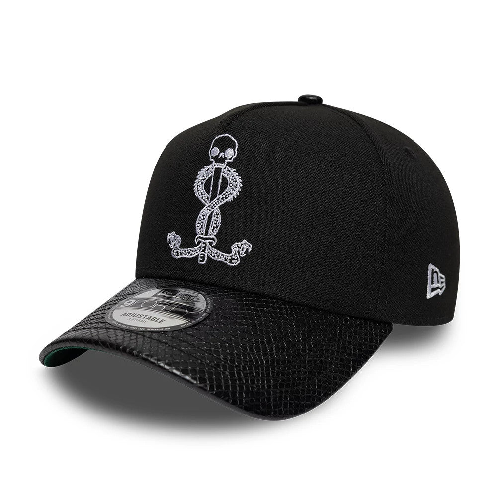 Harry Potter Slytherin Black New Era 9FORTY A-Frame Adjustable Cap, three-quarter view showing the white embroidered Dark Mark symbol on the front panel, black snakeskin-patterned visor with 9FORTY size sticker.