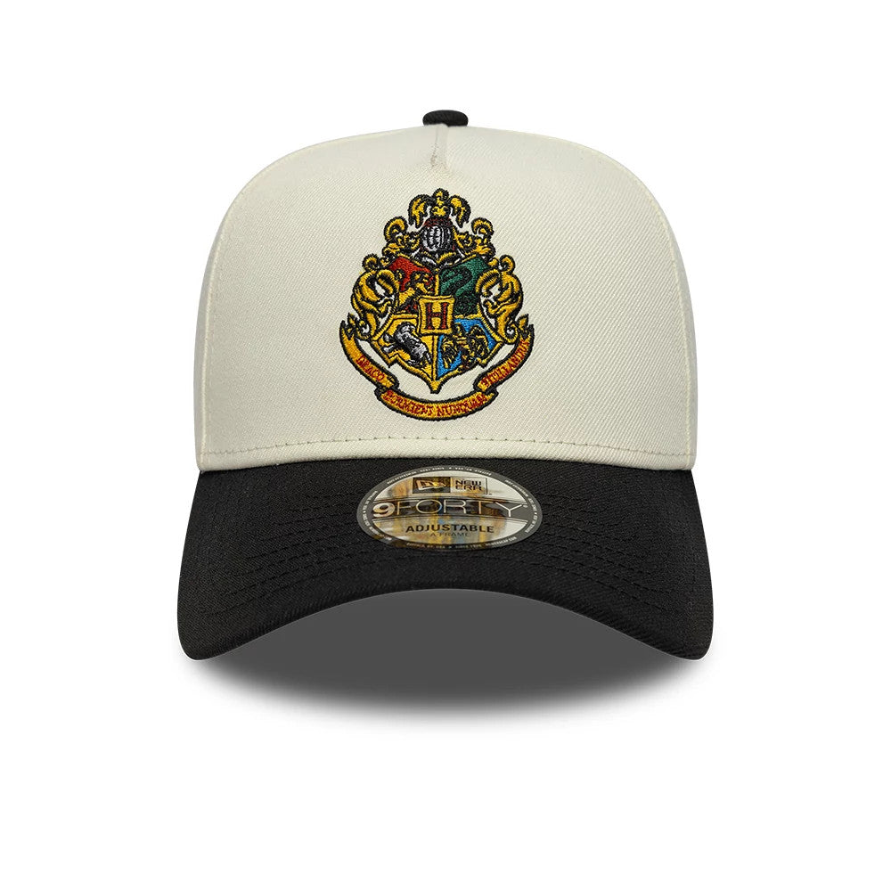 Harry Potter Hogwarts White & Black New Era 9FORTY A-Frame Adjustable Cap, front view showing the colourful embroidered Hogwarts crest on the white structured crown with a contrasting black curved visor and a 9FORTY size sticker on the visor.