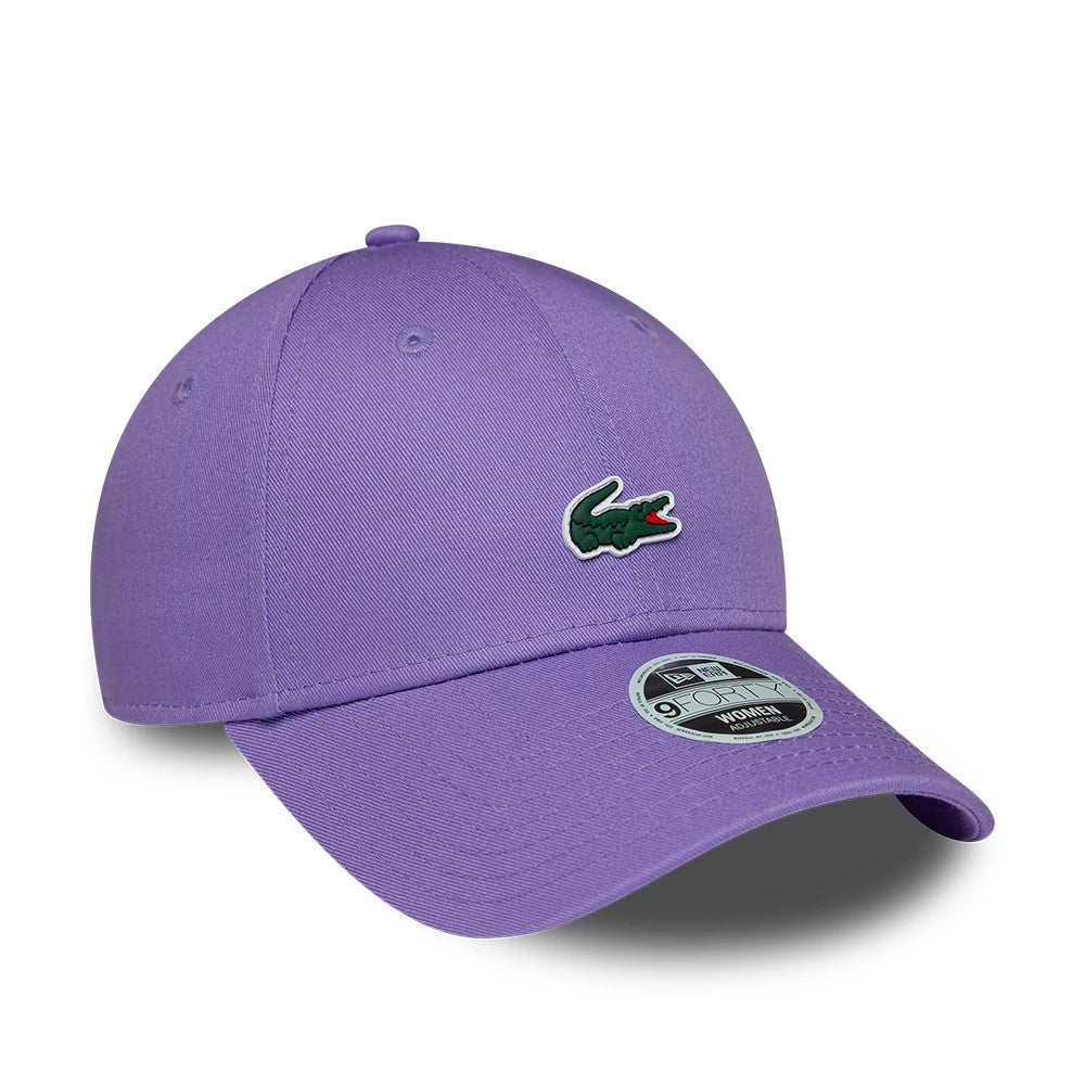 Womens Lacoste X New Era Purple 9FORTY Adjustable Cap, three-quarter view showing the green and red embroidered Lacoste crocodile logo on the front panel, with a curved purple visor and a 9FORTY size sticker on top.