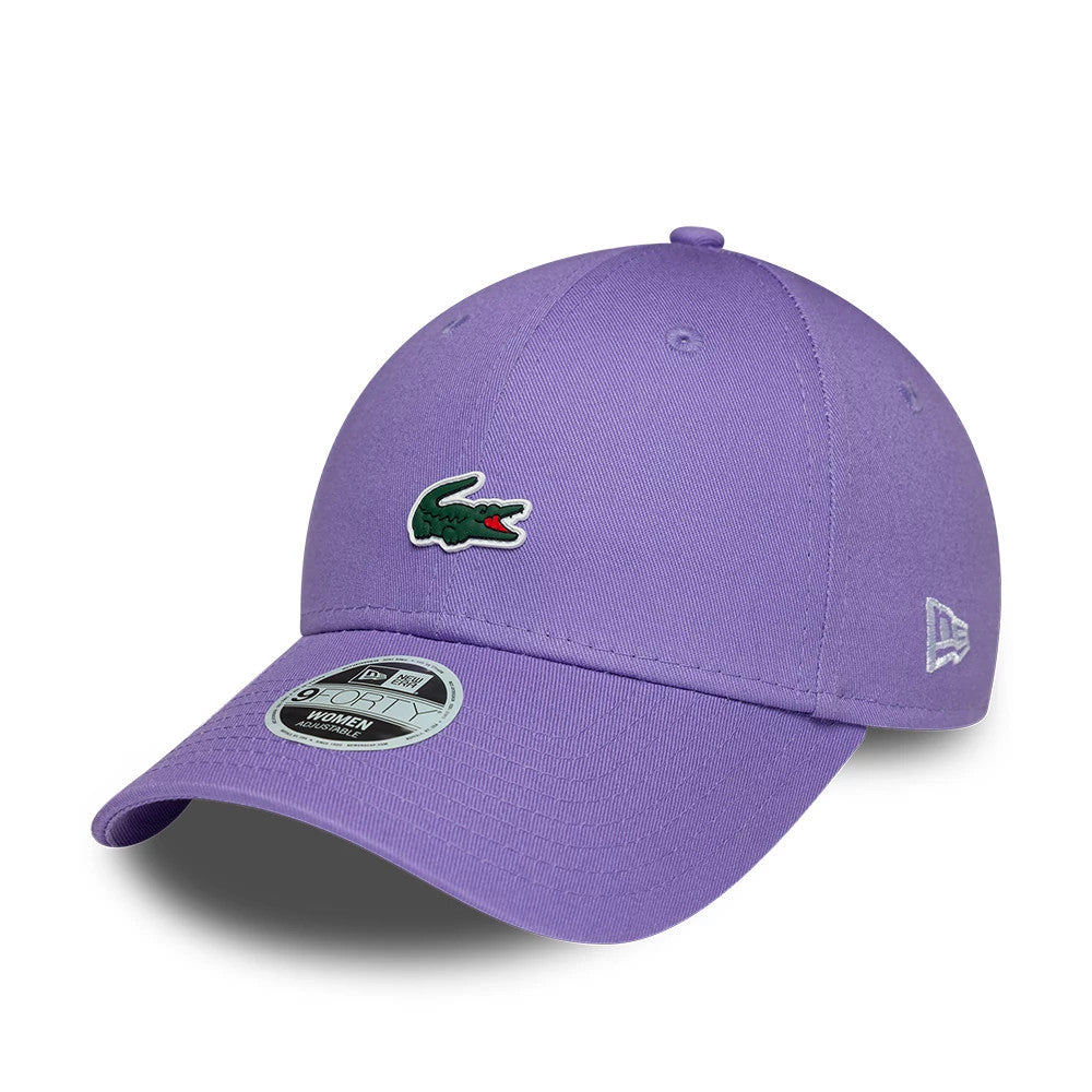 Womens Lacoste X New Era Purple 9FORTY Adjustable Cap, front view showing the green Lacoste crocodile logo embroidered on the purple curved visor, with a 9FORTY size sticker on the visor and the white New Era flag logo on the left side.