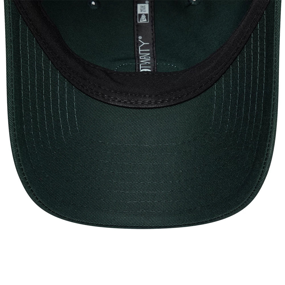 Lacoste X New Era Dark Green 9TWENTY Adjustable Cap, inside view showing the black sweatband lining the interior, dark green undervisor with stitching, and New Era 9TWENTY label along the inner crown seam.