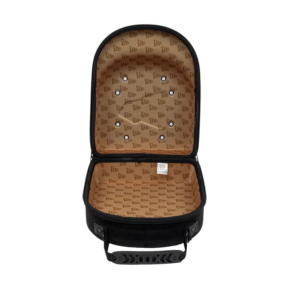 New Era Cord Black 6Pk 59FIFTY Cap Carrier, open view displaying the interior with a tan lining featuring a repeated New Era logo pattern, a row of eyelets on the lid, and a black handle on the side of the case.