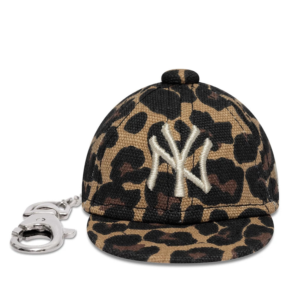 New Era New York Yankees MLB Leo Mini Cap Black Key Chain, front view showing the white embroidered NY logo on a leopard print miniature cap, with a silver keyring attached to the side, and a prominent top button.