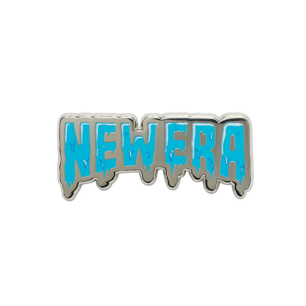New Era Drip Script Silver Pin Badge, front view showing a silver badge with the word NEWERA in blue, designed in a drip script style with a textured finish on the letters, accentuating the unique dripping effect.