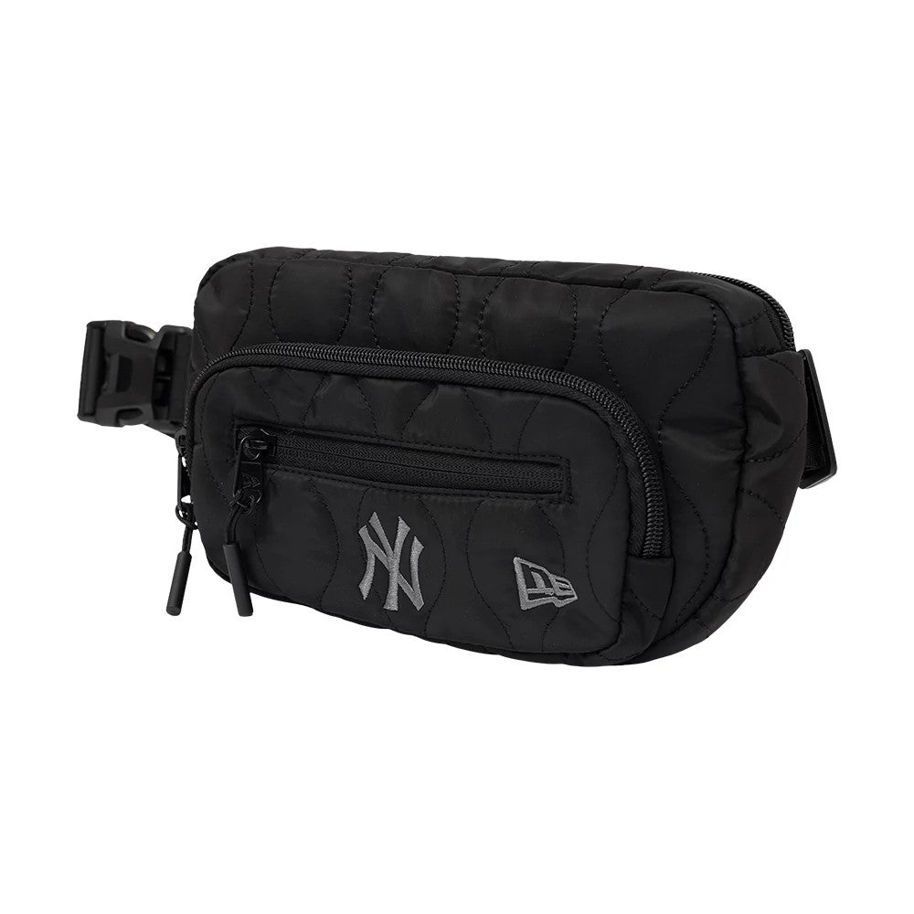 New Era New York Yankees MLB Black Padded Utility Waist Bag, three-quarter view showing the quilted black fabric with a front zip pocket, embroidered New York Yankees logo on the left and New Era logo on the right, and a side-release buckle strap.