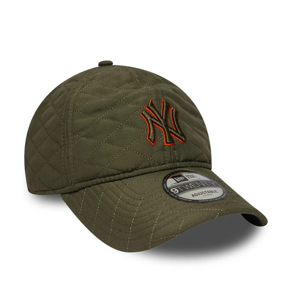 New York Yankees MLB Padded Outline Green New Era 9TWENTY Adjustable Cap, front view showing an orange-outlined NY logo embroidered on the quilted green crown, with a curved visor and a 9TWENTY size sticker on top.