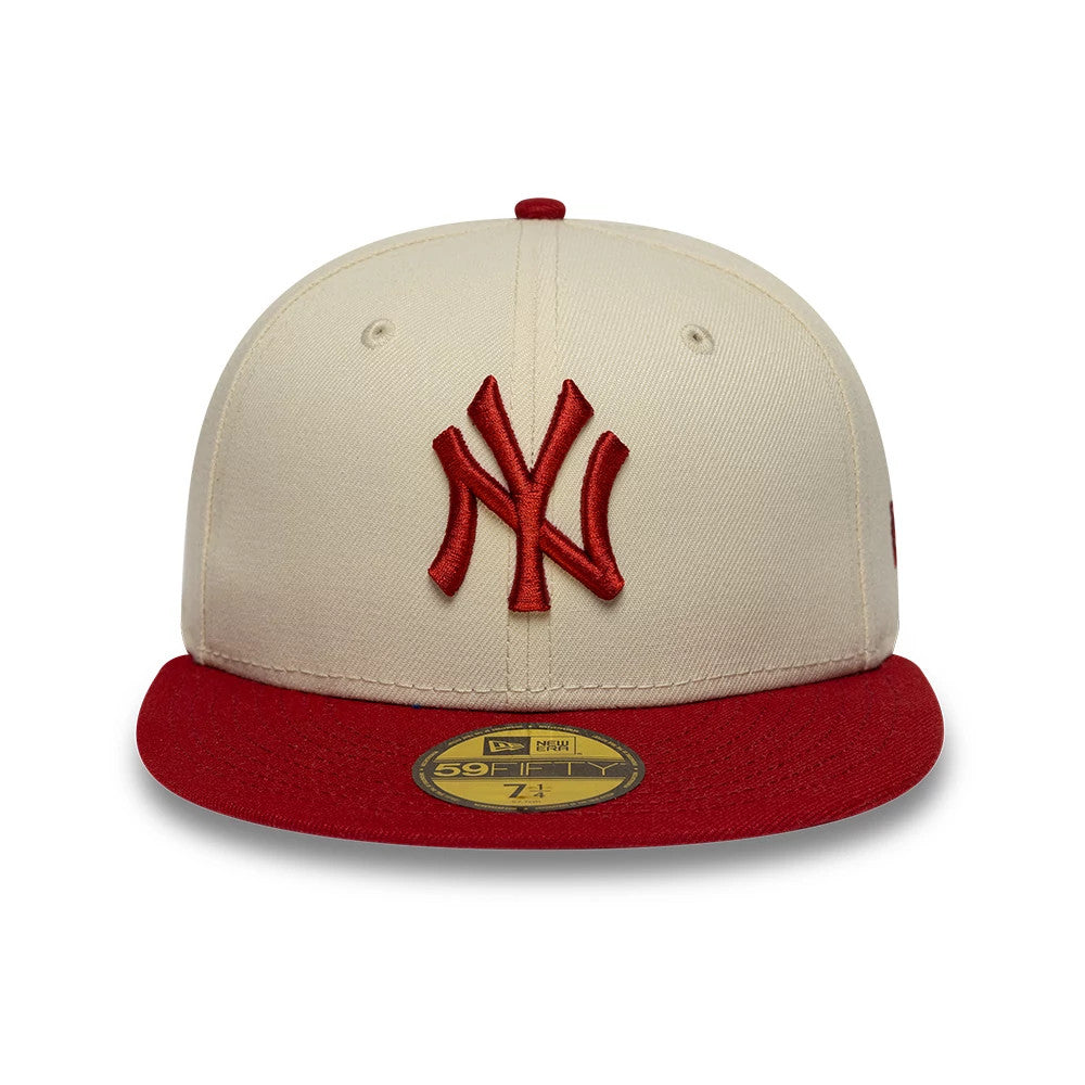 New York Yankees MLB League Essential Cream & Red New Era 59FIFTY Fitted Cap, front view showing a red raised embroidered NY logo on the cream front panel, complemented by a red flat visor and a gold 59FIFTY size sticker.