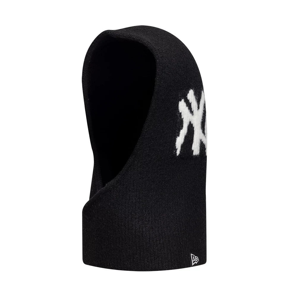 New Era New York Yankees Womens MLB Knitted Black Balaclava Hat, side view showing the prominent white NY logo on the side, contrasting the black knit fabric, with the New Era flag logo near the lower edge.