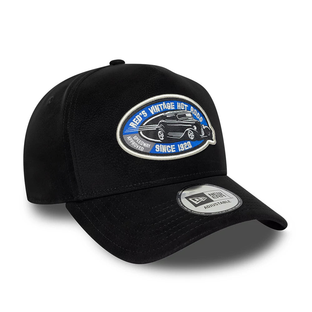 New Era Moto Patch PU Black New Era 9FORTY E-Frame Adjustable Cap, three-quarter view showing a raised embroidered oval patch with a car graphic on the front panel, featuring a curved black visor with a 9FORTY size sticker.