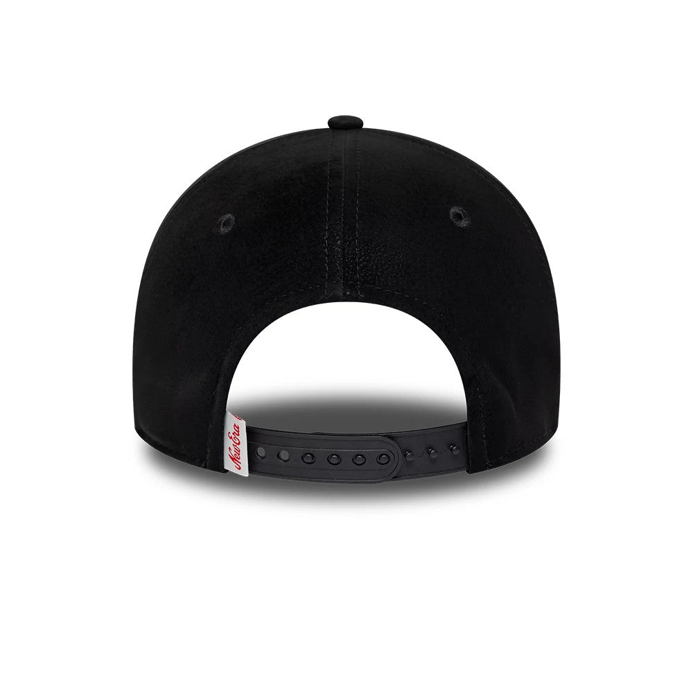 New Era Moto Patch PU Black 9FORTY E-Frame Adjustable Cap, rear view showing the black structured crown with eyelets, a red New Era script logo on a white tab at the bottom edge, and a black adjustable strap closure.