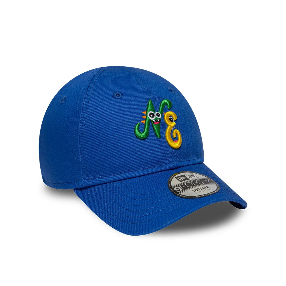 Toddler New Era Monster Icon Blue 9FORTY Adjustable Cap, three-quarter view showing colourful monster-themed NE embroidery on the front panel, with a curved blue visor and 9FORTY size sticker on the visor.