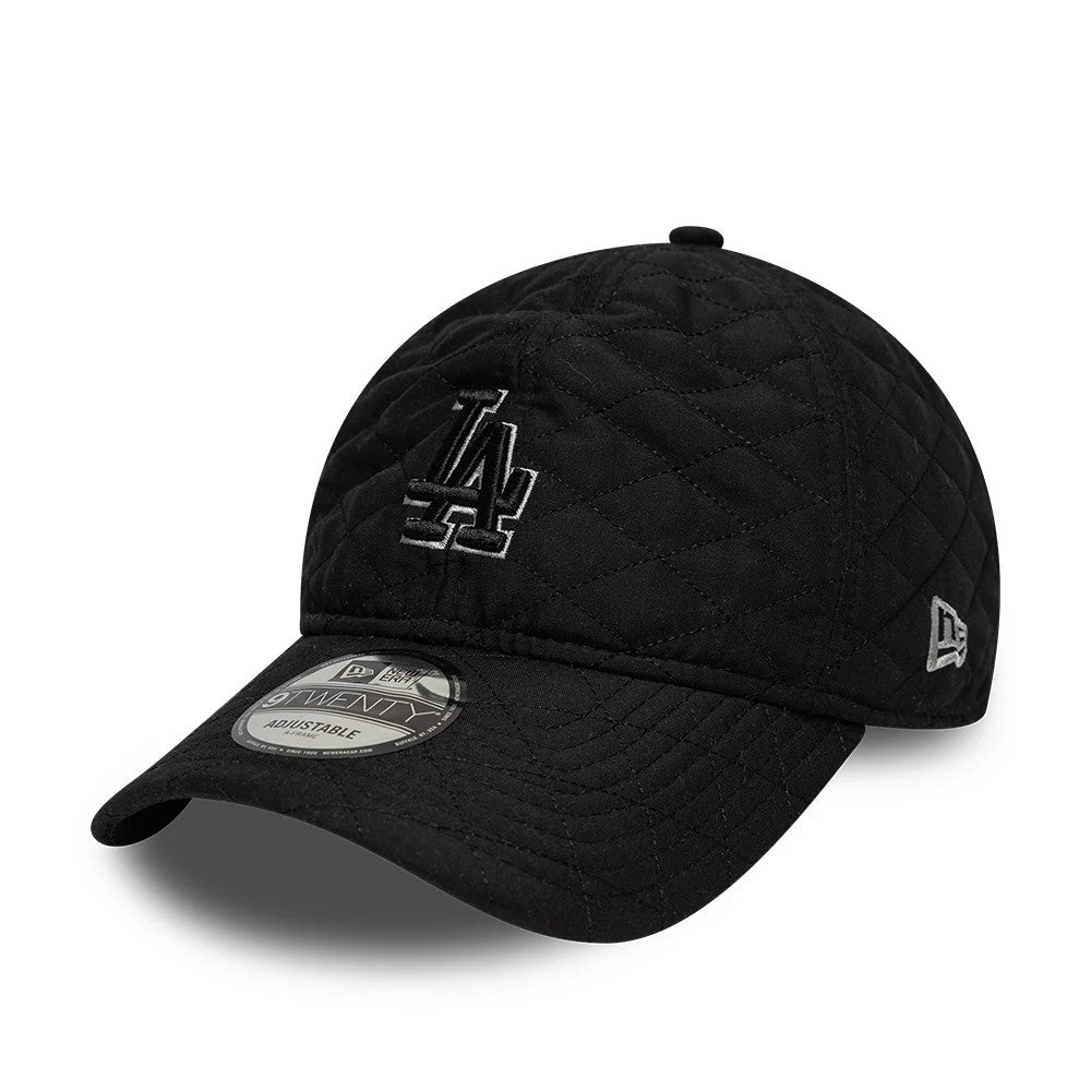 LA Dodgers MLB Padded Outline Black New Era 9TWENTY Adjustable Cap, three-quarter view showing a raised black and grey embroidered LA logo on the front panel, with a quilted fabric texture and a 9TWENTY size sticker on the curved visor.