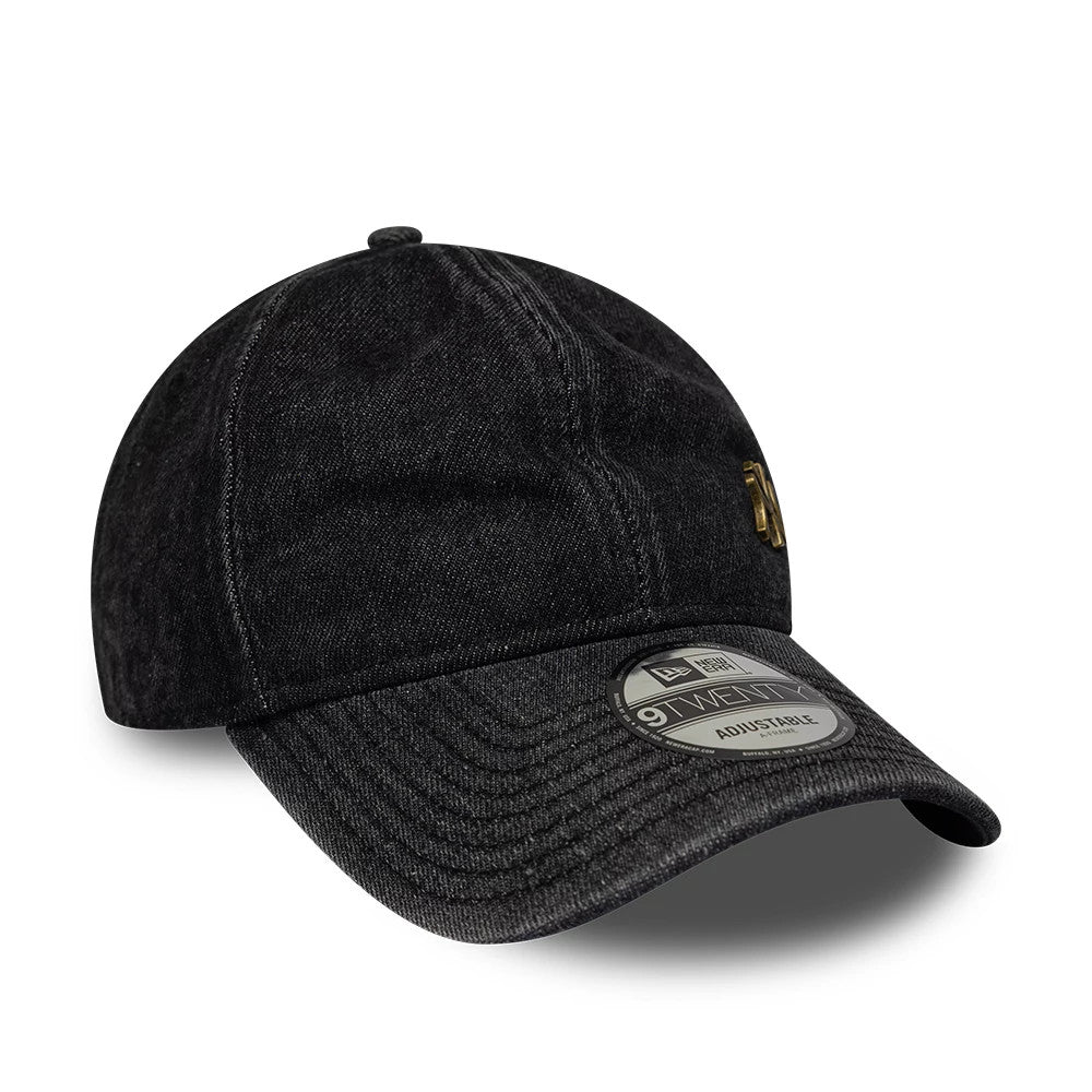 New York Yankees MLB Washed Denim Black New Era 9TWENTY Adjustable Cap, three-quarter view showing the gold embroidered NY logo on the front panel, a curved denim visor with a 9TWENTY size sticker, and an unstructured black denim crown.