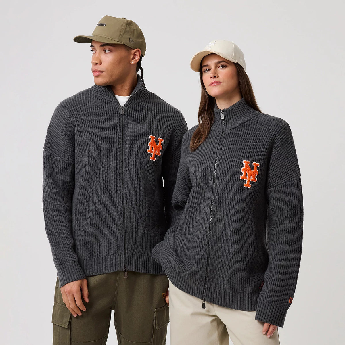 New Era New York Mets MLB Charcoal 2 Way Zip Cardigan, front view on a model with ribbed texture, featuring the orange and white Mets logo embroidered on the left chest, with a high collar and full-length zip fastening.