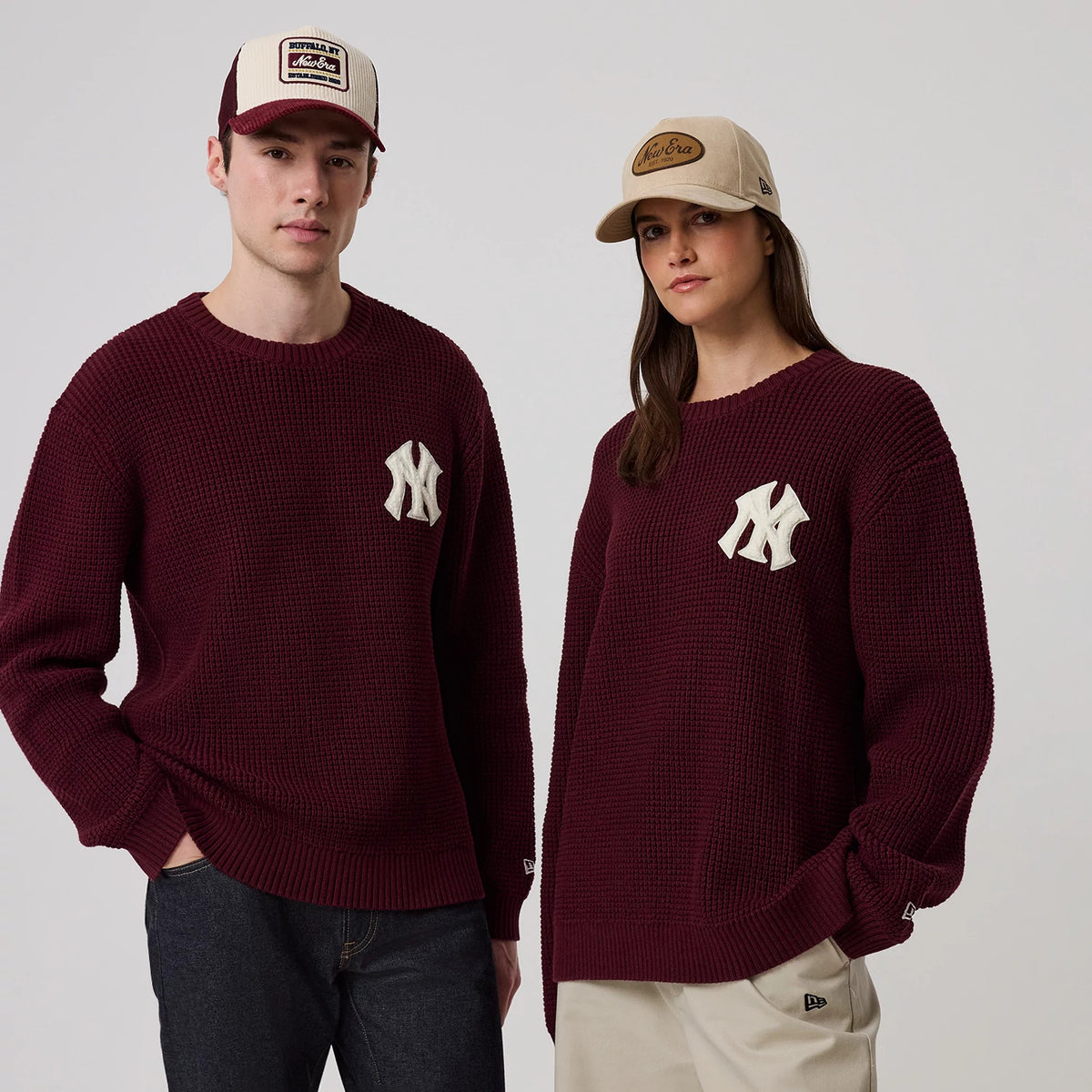 New Era New York Yankees MLB Waffle Knit Dark Purple Crew Neck Sweater, front view on two models showing the large white Yankees logo on the left chest, the chunky waffle knit texture.